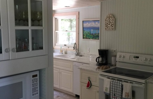 Menonaqua Beach Cottage | Charming Harbor Springs cottage right on the sandy beach and crystal water