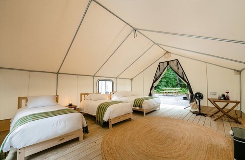 Corinth RV Rental | Luxury Group Safari Tent Complete with Firepit and Patio, Perfect for a Weekend Escape to the Adirondacks