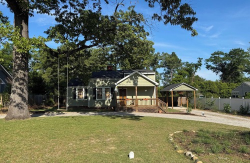Pendleton King House | Masters rental with spacious back porch, fenced in yard, and park frontage.
