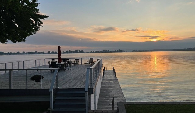 Beautifully updated home on the bay and golf course with dock and raised deck!