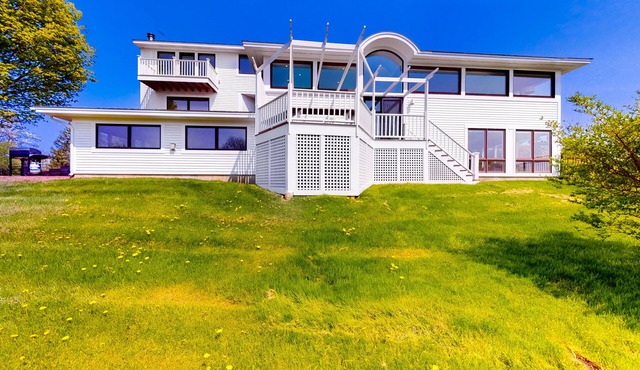 Gorgeous home with amazing lake views, fireplace, firepit, hot tub, & balcony