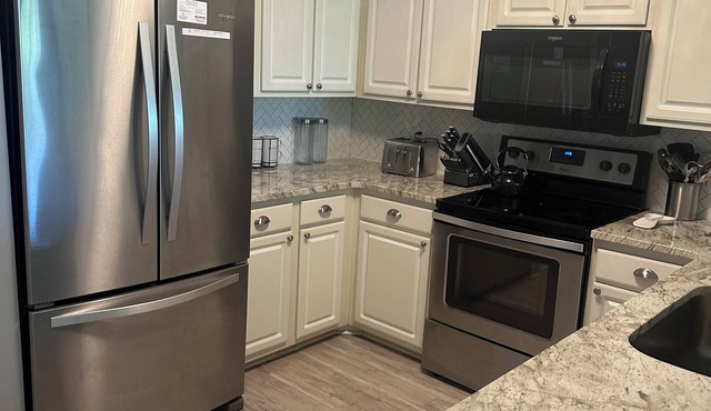Updated 3 bedroom 2 full bath condo on True Blue's Golf Course with water view.