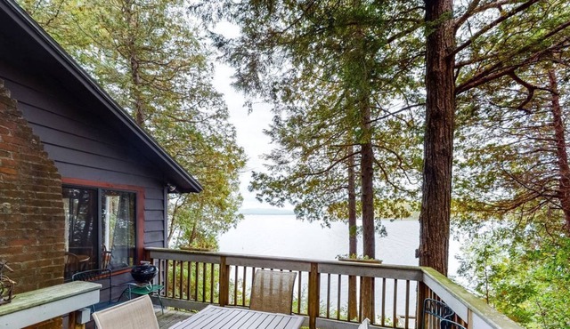 Updated lakefront home in a wooded setting with private dock & beach access